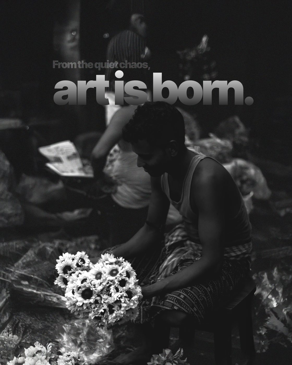 A flower seller working over white blooms picked out in colour against black and white, captioned From the quiet chaos, art is born