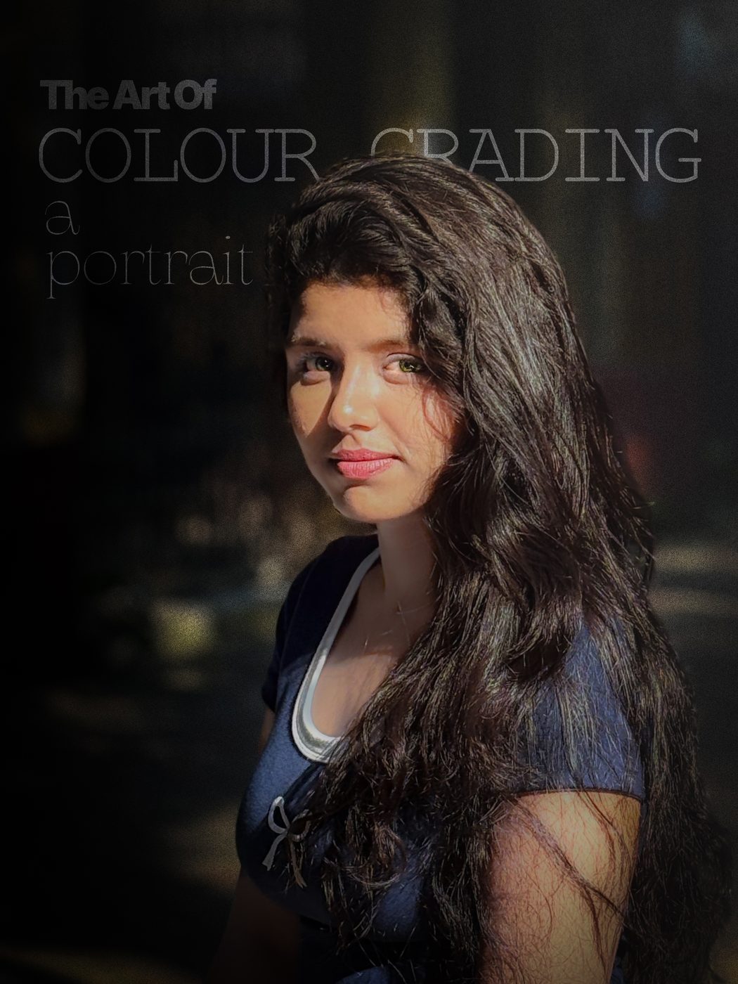 A portrait of a young woman in low light, titled The art of colour grading a portrait
